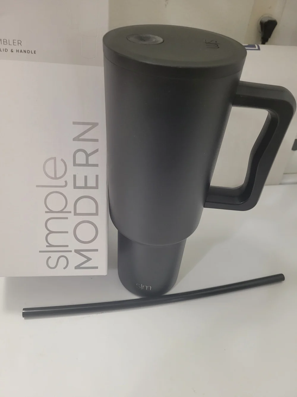 The 40 oz Trek Tumbler with Handle and Straw Lid is a reusable insulated tumbler